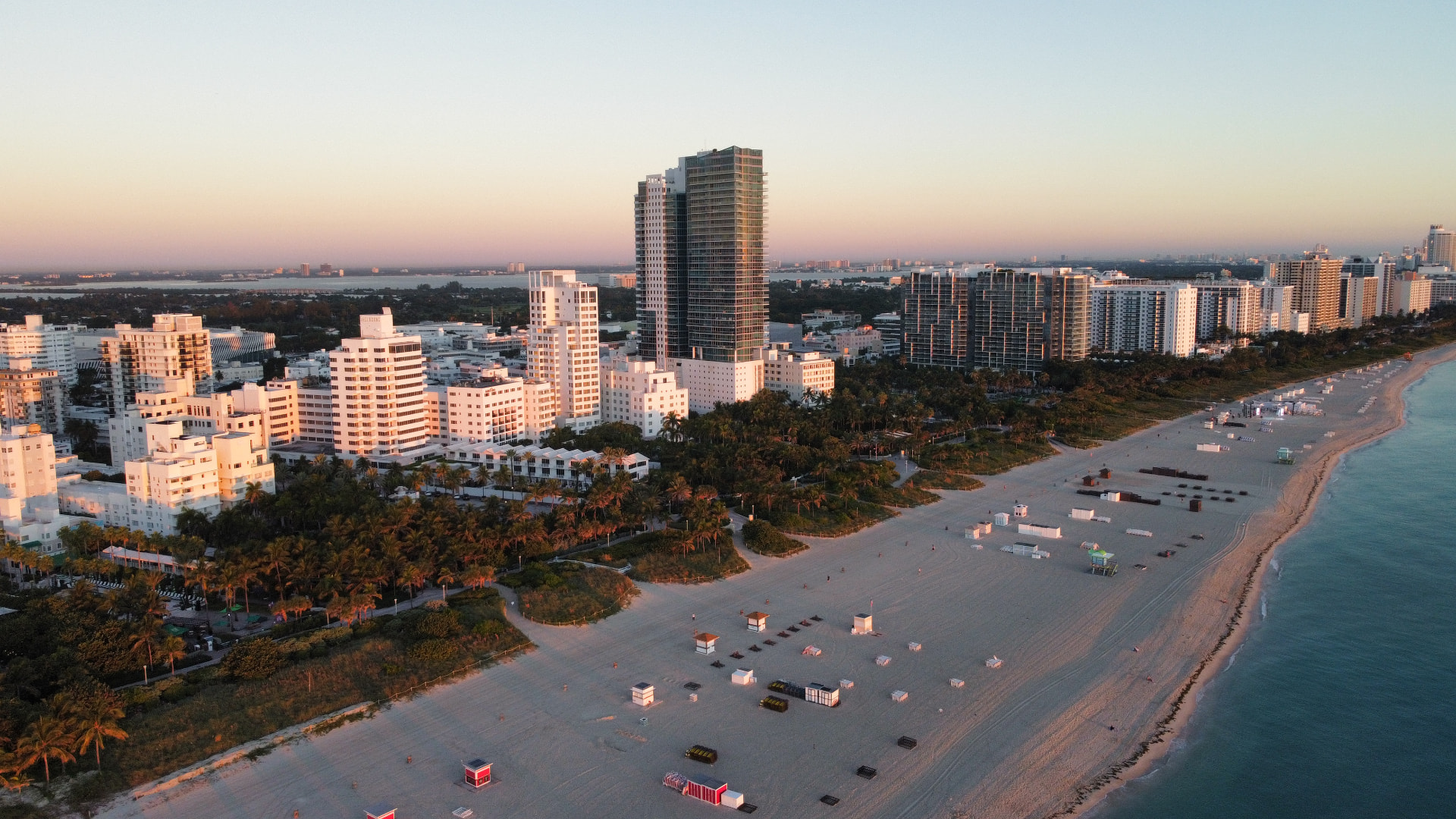 Miami Beach shoreline and oceanfront towers at sunrise — aerial view