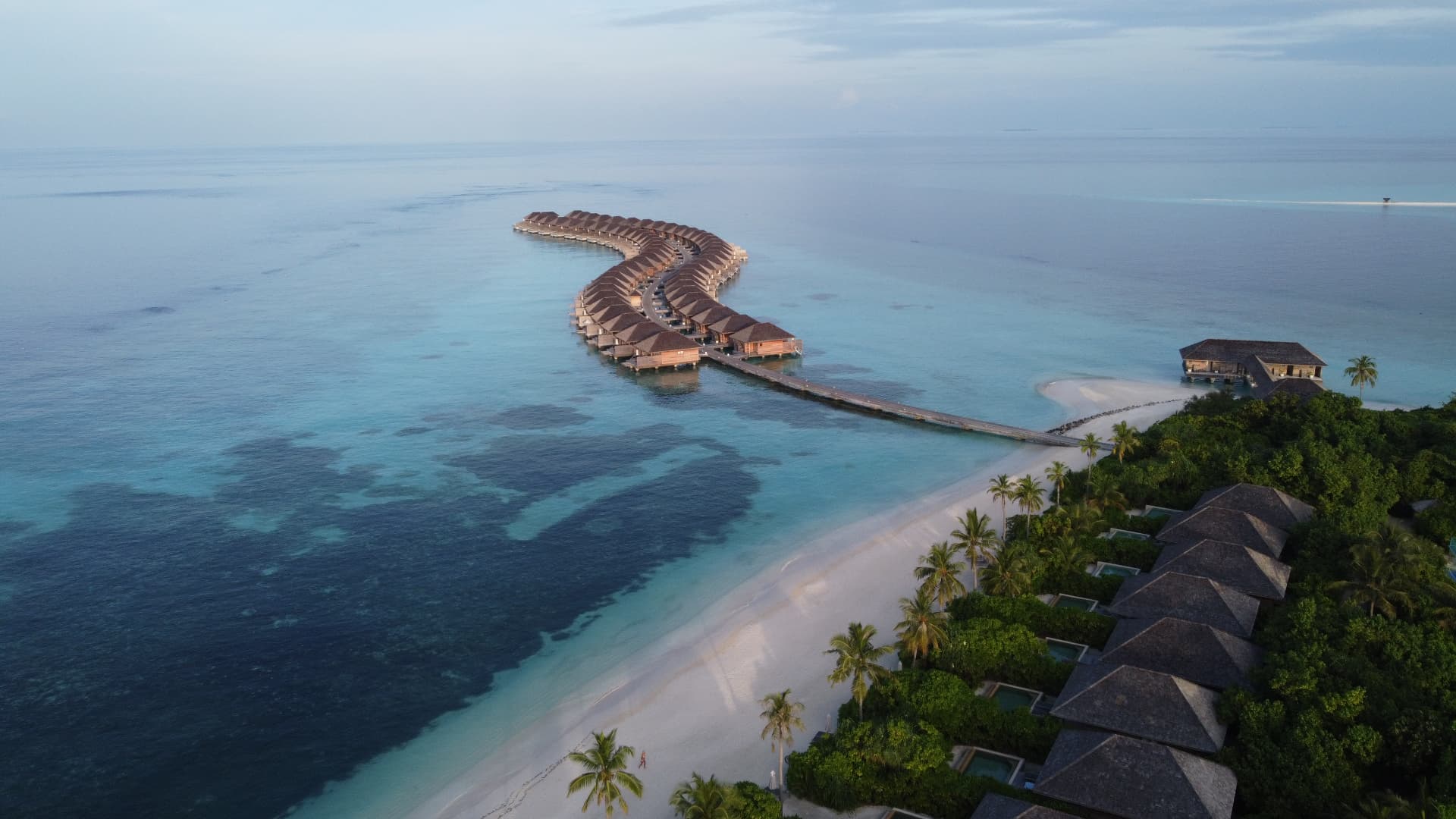 Aerial view of overwater villas stretching along a turquoise lagoon, Maldives