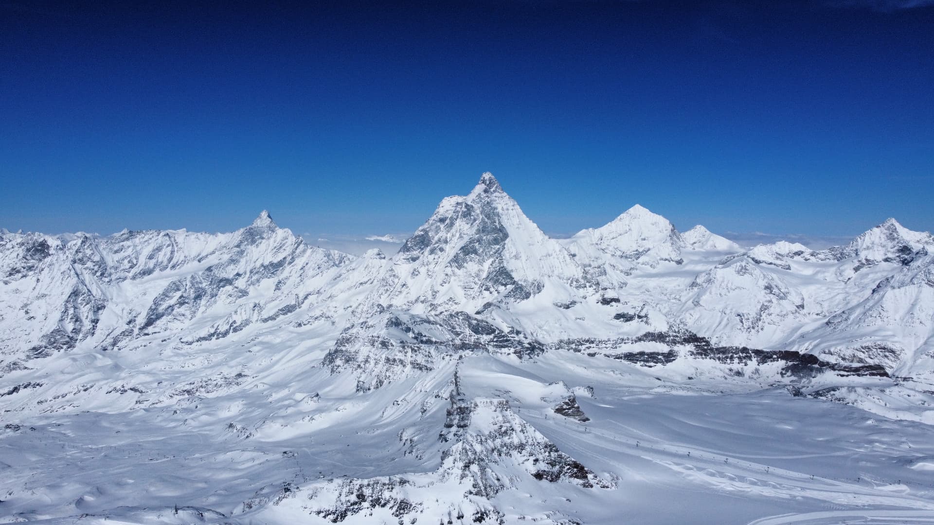 Panorama of the snow-covered Alpine peaks around Zermatt under a clear sky